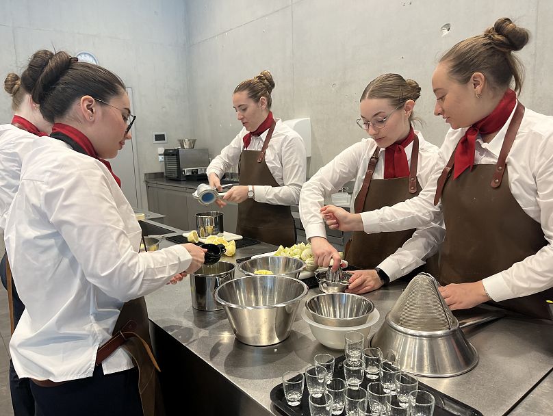 Students mix limes in cocktail mixology class.