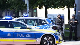 Police officers patrol near a scene after police fired shots at a suspicious person near the Israeli Consulate