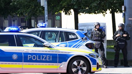 Police officers patrol near a scene after police fired shots at a suspicious person near the Israeli Consulate