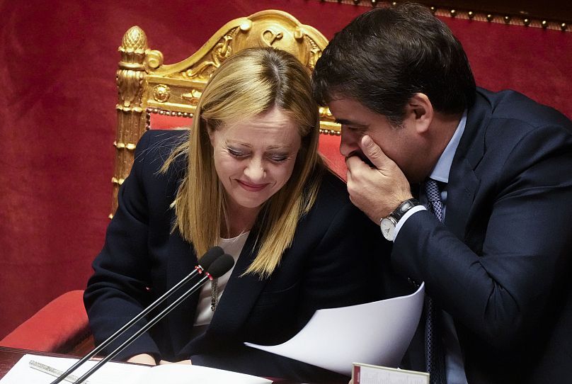 Italian Premier Giorgia Meloni listens to Raffaele Fitto, minister for European Affairs after addressing the Italian senate in Rome, 21 March 2023