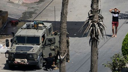 Israeli soldiers arrest a Palestinian man during a military operation in Jenin, West Bank, Thursday, Sept. 5, 2024.