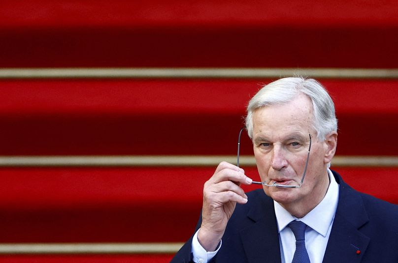 Michel Barnier accepts the French prime ministership at a handover ceremony.