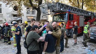 Medics give first aid to Yaroslav Bazylevych, who lost his family in a Russian missile attack in the western city of Lviv, Ukraine, Wednesday, Sept. 4, 2024.