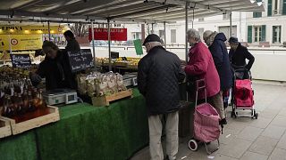 People shop at an open air market in Fontainebleau, south of Paris, France