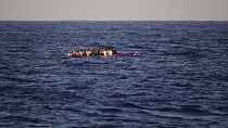 Migrants and refugees fleeing Libya on board of a wooden boat sail at the Mediterranean sea toward the Italian coasts, about 17 miles north of Sabratha, Libya, Sunday, Aug. 28