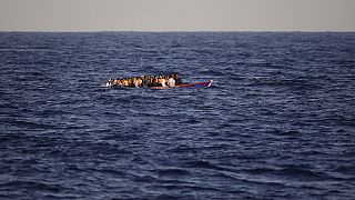 Migrants and refugees fleeing Libya on board of a wooden boat sail at the Mediterranean sea toward the Italian coasts, about 17 miles north of Sabratha, Libya, Sunday, Aug. 28