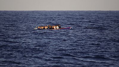 Migrants and refugees fleeing Libya on board of a wooden boat sail at the Mediterranean sea toward the Italian coasts, about 17 miles north of Sabratha, Libya, Sunday, Aug. 28