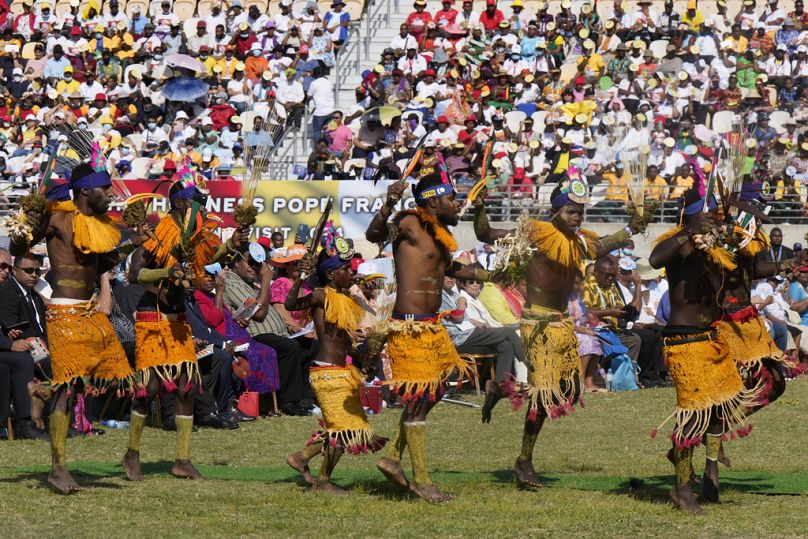 Dancers in traditional dress perform as Pope Francis holds a holly mass at Sir John Guise Stadium in Port Moresby, Papua New Guinea, Sunday, Sept. 8, 2024. 