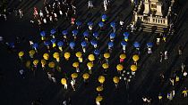 People with umbrellas gather at the Old Town Square in support of Ukraine in Prague, Czechia, Saturday, Sept. 7, 2024.