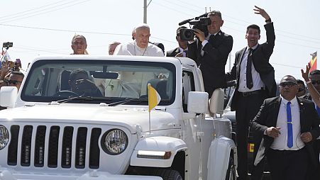 Pope Francis in a car, is welcomed in Dili, East Timor, Monday, Sept. 9, 2024.