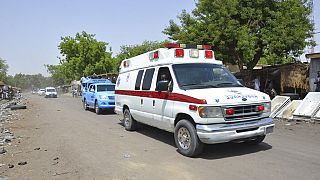 An ambulance and security cars drive to the site of a suicide bomb attack at a market in Maiduguri, Nigeria, Tuesday, June 2, 2015.