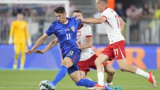 Croatia's Ante Budimir, left, challenges for the ball with Poland's Karol Swiderski, right, and Poland's Pawel Dawidowicz in Osijek, Croatia, Sunday, Sept. 8 2024