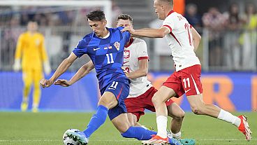 Croatia's Ante Budimir, left, challenges for the ball with Poland's Karol Swiderski, right, and Poland's Pawel Dawidowicz in Osijek, Croatia, Sunday, Sept. 8 2024