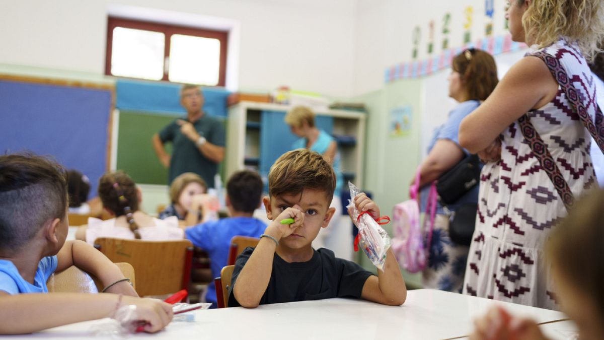 Filippos and other students attend the first day of school at a public elementary school in Athens, on Wednesday, Sept. 11, 2024. 