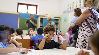 Filippos and other students attend the first day of school at a public elementary school in Athens, on Wednesday, Sept. 11, 2024. 