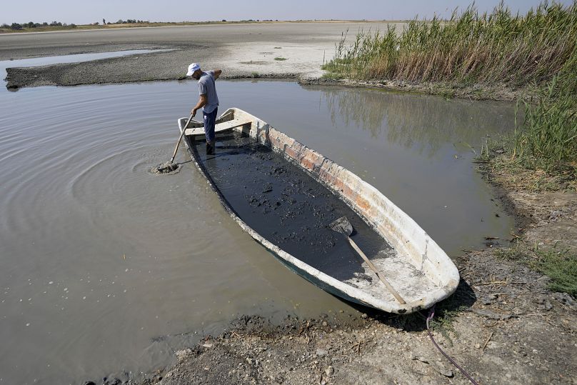 Un hombre recoge barro para utilizarlo en terapia médica del lago salado Rusanda, que se ha secado por completo, cerca de Melenci, Serbia.