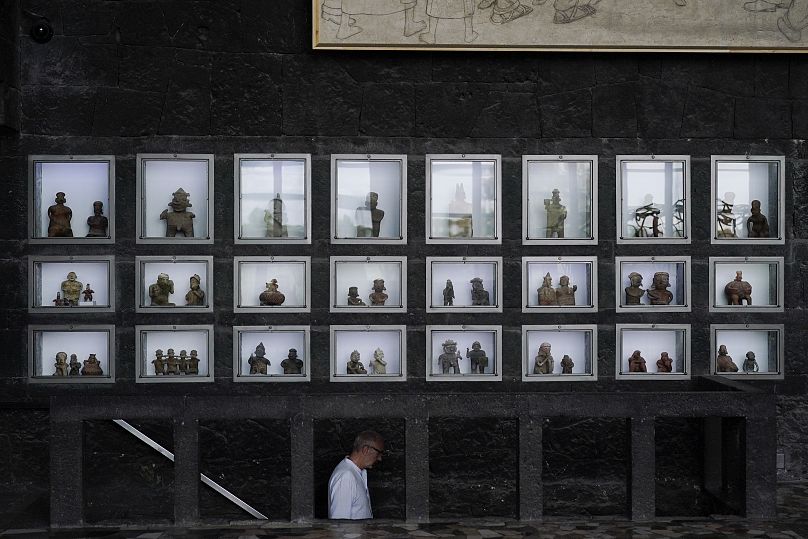 Pre-hispanic ceramics are displayed in glass front niches in the Anahuacalli Museum in Mexico City.