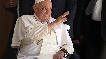 Pope Francis greets people in the Cathedral of the Immaculate Conception