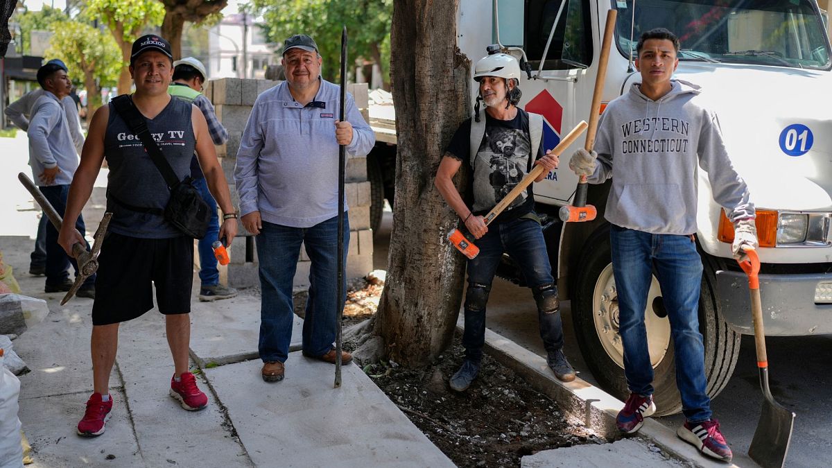 Arturo Hernandez, second from right, poses next to members of The Tree Army, a group that works to improve the urban forest in Mexico City, 26 August 2024. 