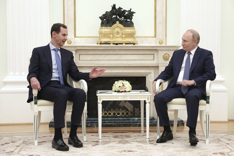 Syrian President Bashar Assad speaks with Russian President Vladimir Putin during their meeting in Moscow, July 2024