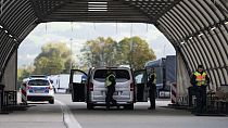 FILE - German federal police officers check a van at the Austrian-German border crossing point in Kiefersfelden, Germany, Oct. 9, 2023.