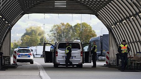 FILE - German federal police officers check a van at the Austrian-German border crossing point in Kiefersfelden, Germany, Oct. 9, 2023.