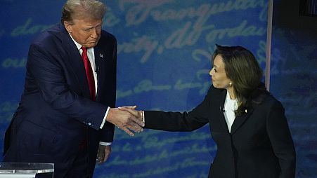 Republican presidential nominee former President Donald Trump shakes hands with Democratic presidential nominee Vice President Kamala Harris 