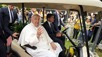 Papa Francisco acena para cumprimentar os voluntários em sua chegada a Cingapura, quarta-feira, 11 de setembro de 2024.