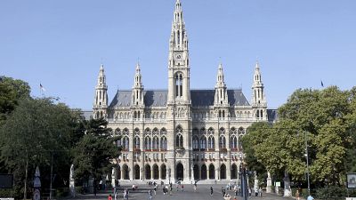 People walk in front of the City Hall in downtown Vienna.