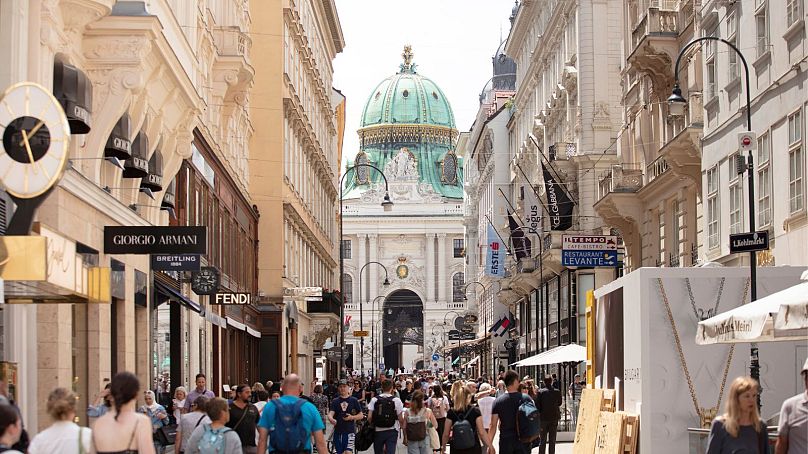 People walk on the shopping street Kohlmarkt in Vienna.