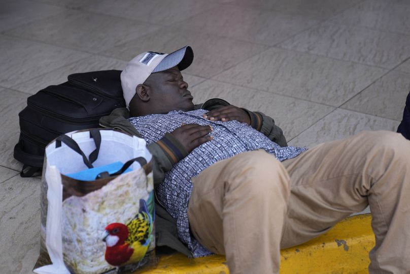 A stranded passenger takes a nap as he wait for delayed flight out of JKIA airport in Nairobi, Kenya Wednesday, Sep. 11, 2024. Brian Inganga/Copyright 2023 The AP. All rights reserved