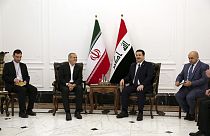 Iranian President Masoud Pezeshkian, center left, and Iraqi Prime Minister Mohammed Shia al-Sudani, center right, meet at the government palace in Baghdad, Iraq, Wednesday, Se