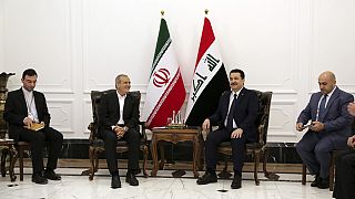 Iranian President Masoud Pezeshkian, center left, and Iraqi Prime Minister Mohammed Shia al-Sudani, center right, meet at the government palace in Baghdad, Iraq, Wednesday, Se