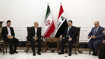 Iranian President Masoud Pezeshkian, center left, and Iraqi Prime Minister Mohammed Shia al-Sudani, center right, meet at the government palace in Baghdad, Iraq, Wednesday, Se