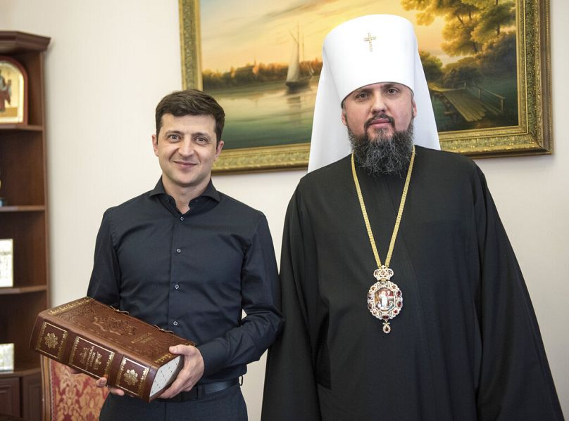 April 30, 2019, Volodymyr Zelenskiy, left, poses for a photo with Metropolitan Epiphanius, head of the Orthodox Church of Ukraine, in Ki