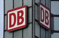 Two logos of the 'Deutsche Bahn' (German Railroad) are pictured at the main train station in Berlin, Germany. 3 January 2022.