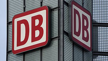 Two logos of the 'Deutsche Bahn' (German Railroad) are pictured at the main train station in Berlin, Germany. 3 January 2022.