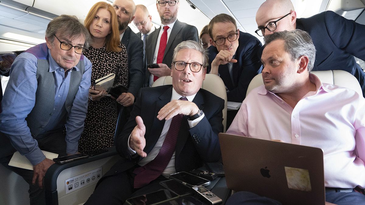 Britain's Prime Minister Keir Starmer talks to the media on board his plane as he flies to Washington DC, September 12, 2024