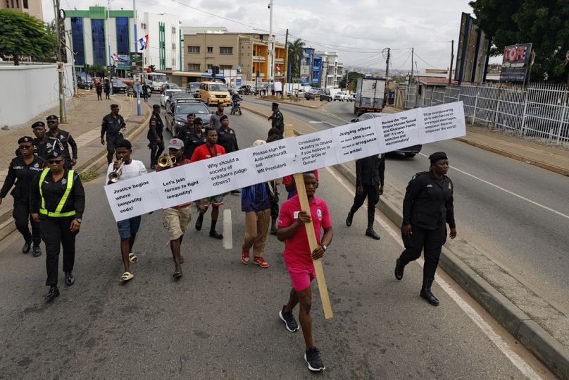 Texas Kadri Moro, the Executive Director of Arise for Justice International, protests with placards nailed on a cross on the street of Accra, Ghana, Thursday Sept 12, 2024.