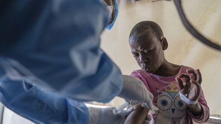 FILE - A health worker attends to an mpox patient, at a treatment center in Munigi, eastern Congo, Aug. 19, 2024.