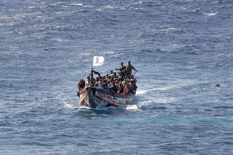 Migrants crowd a wooden boat as they sail to the port in La Restinga on the Canary island of El Hierro.