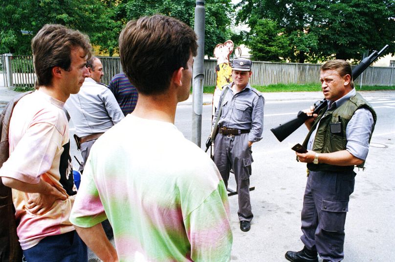 Two young men in the town of Slovenska Bistrica, Slovenia, 9 July 1991