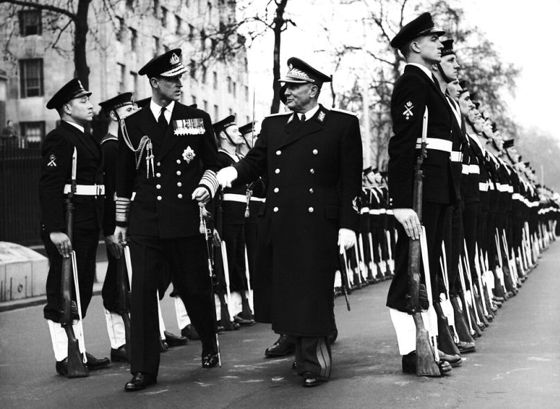 Accompanied by the Duke of Edinburgh, left, wearing Admiral’s uniform, Josip Broz Tito inspects the Naval Guard of Honour on his arrival at Westminster, London, 15 March 1953