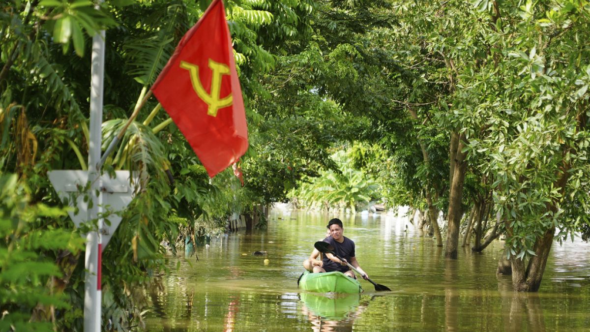 A man paddles a boat in the flood in the aftermath of Typhoon Yagi in An Lac village, Hanoi, Vietnam Friday, Sept. 13, 2024.