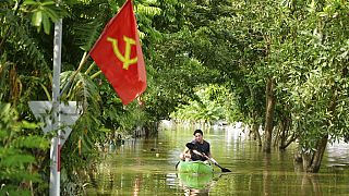 A man paddles a boat in the flood in the aftermath of Typhoon Yagi in An Lac village, Hanoi, Vietnam Friday, Sept. 13, 2024.