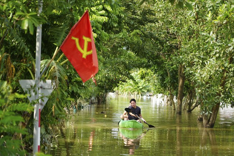 A man paddles a boat in the flood in the aftermath of Typhoon Yagi in An Lac village, Hanoi, Vietnam Friday, Sept. 13, 2024.