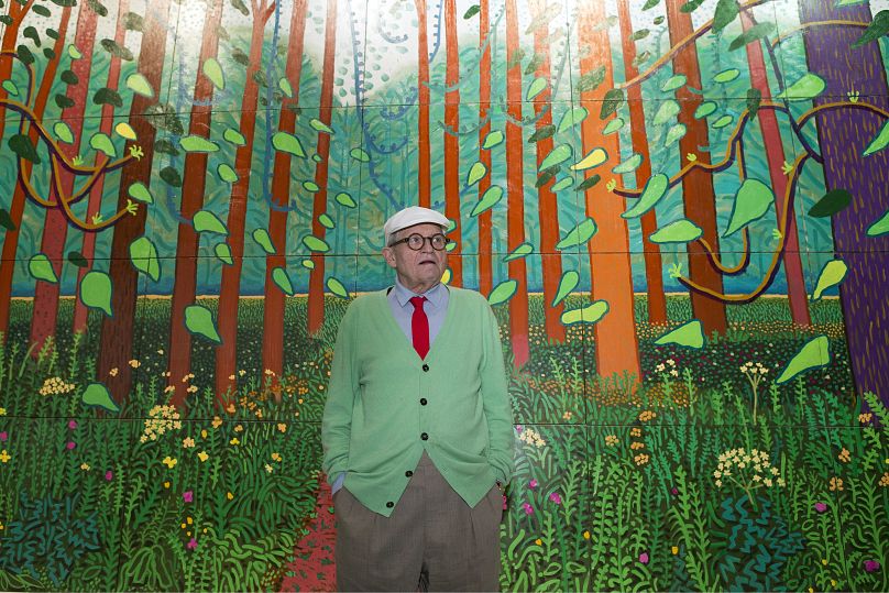 David Hockney poses during the unveiling of a huge painting he is donating to the Pompidou Centre in Paris, "The Arrival of Spring in Woldgate, East Yorkshire.", in 2017