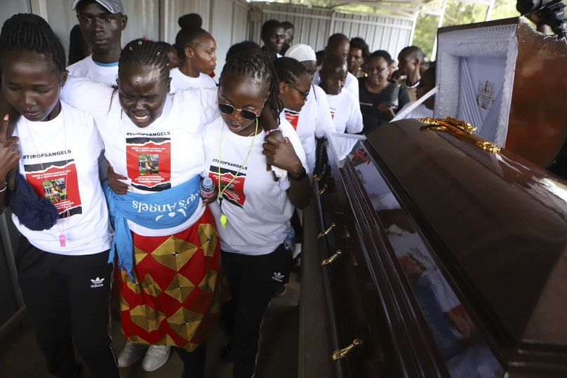 Relatives try to comfort a woman crying after viewing the body of Ugandan Olympic athlete Rebecca Cheptegei at Moi Teaching and Referral Hospital morgue in the western city of