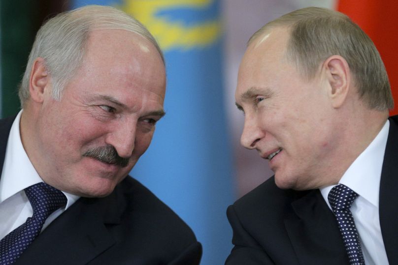 Russian President Vladimir Putin, right, and his Belarus counterpart, Alexander Lukashenko, talk at an economic summit in the Kremlin, in Moscow, Russia, on Dec. 23, 2014. 