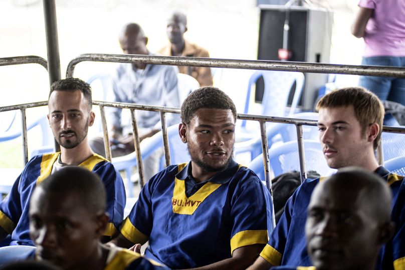 From left Tyler Thompson Jr., Marcel Malanga and Benjamin Reuben Zalman-Polun, right, all American citizens, face the court in Kinshasa with 52 other defendants on 03/06/24.